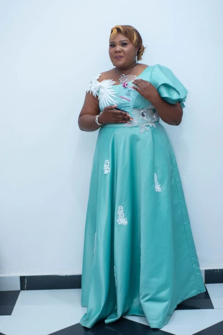 CEO presenting her award in a turquoise gown