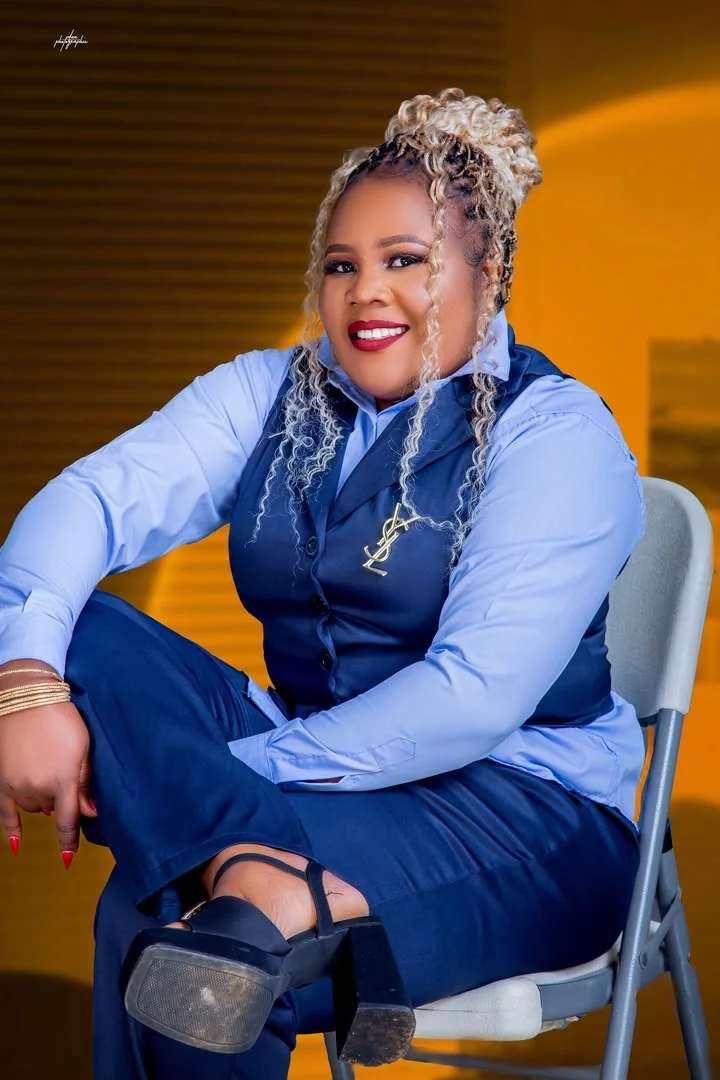 CEO seated and smiling against a warm golden background